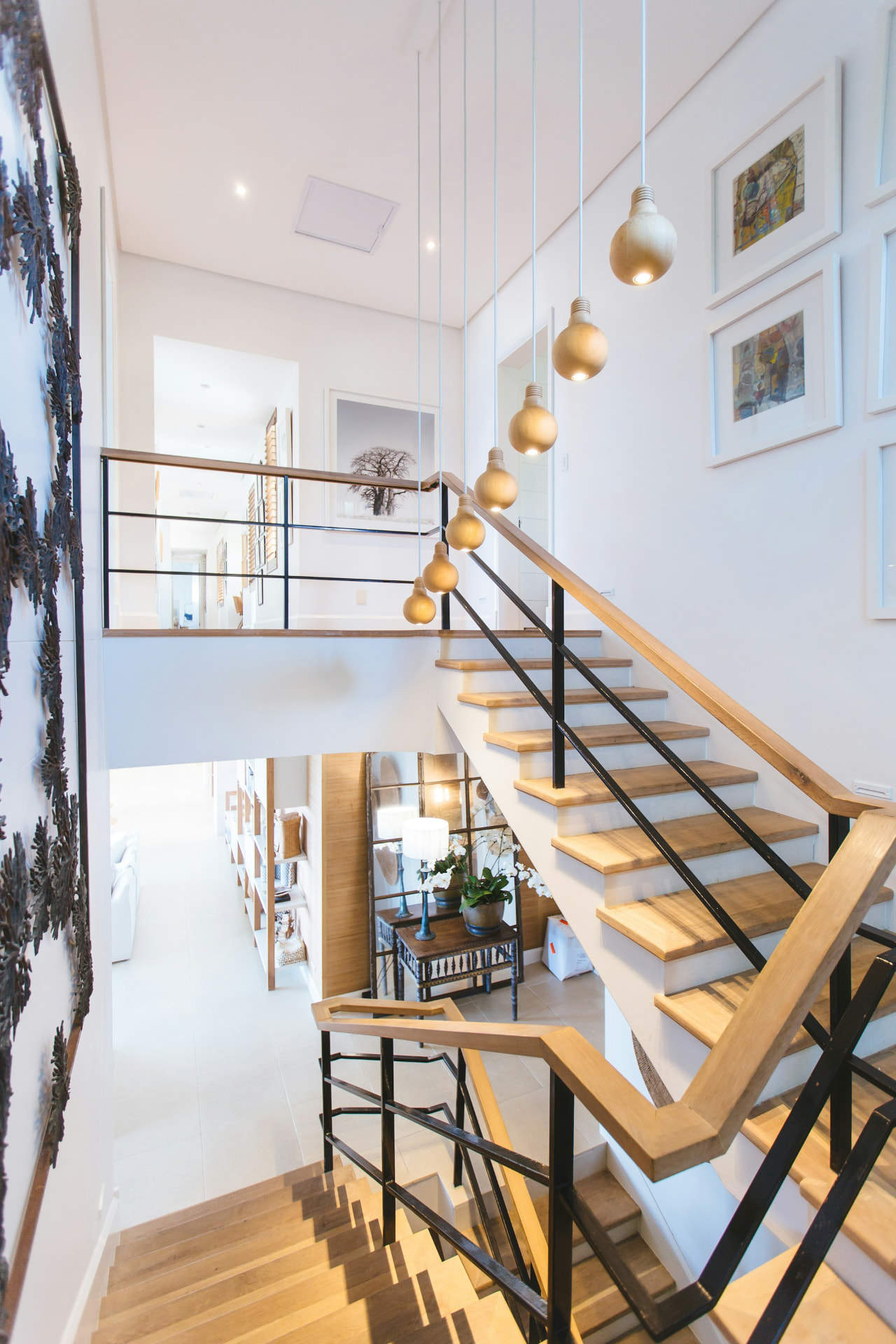 Renovated staircase with warm oak treads and pendant lighting